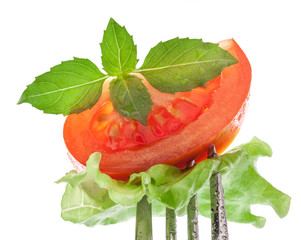 Wall Mural - Slice of tomato on the fork, isolated on white