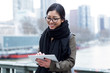 © nenetus - Beautiful asian young woman using her digital tablet in front of Seine river in Paris.