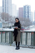 © nenetus - Beautiful asian young woman using her digital tablet in front of Seine river in Paris.