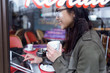 © nenetus - Beautiful young asian woman using her digital tablet while drinking coffee in coffee shop.