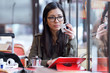 © nenetus - Beautiful young asian woman using her digital tablet while drinking coffee in coffee shop.