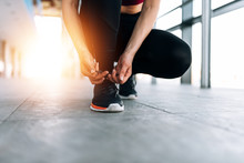 Sport Lifestyle. Close-up Of Female Runner Tying Shoelace.