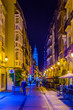 People are strolling a street in Logrono during night