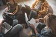 © Yakobchuk Olena - Calm guys and girls taking seats on beanbags and doing their work. Men using notebooks. Woman checking time on smartwatch