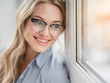 © Yakobchuk Olena - Portrait of happy blond businesswoman enjoying view from the window and smiling