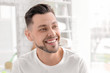 © New Africa - Young man with beautiful smile indoors. Teeth whitening