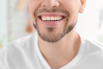 Wall Mural - Young man with beautiful smile indoors. Teeth whitening