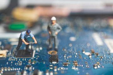 miniature people : worker team of engineers repairing keyboard computer laptop