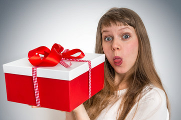 Pretty smiling woman with red gift box