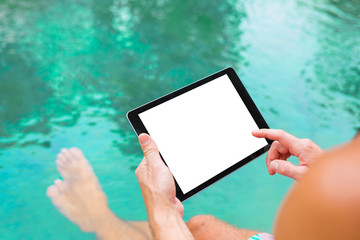 Poster - Man using tablet while sitting by the pool