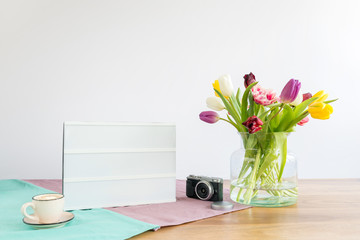 Wall Mural - Light box with copy space and flowers on wooden desk with white background