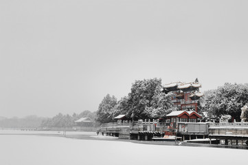 Old steam locomotive in the mountain village in the snow.