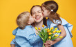 concept of mother's day. mom and children with flower on colored background