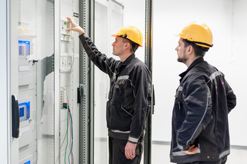 Wall Mural - field service crew testing electronics or inspecting electrical installation system