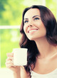 © vgstudio - woman drinking coffee or tea, at home