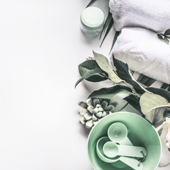 Wall Mural - modern spa background with white towels, tools and green herbs, top view, place for your design. wel