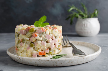 Russian traditional salad Olivier with vegetables and meat