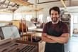 © mavoimages - Smiling woodworker standing by a bench saw in his workshop