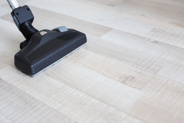 Wall Mural - close up of modern vacuum cleaner over wooden parquet floor