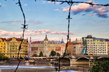 Poster - buildings of Prague behind wire mesh