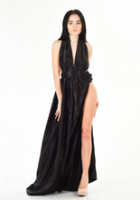 Lady, Sexy Girl In Dress. Fashion Dress Concept. Woman In Elegant Black Long Evening Dress With Decollete, White Background. Attractive Girl Wears Expensive Fashionable Evening Dress With Erotic Slit.