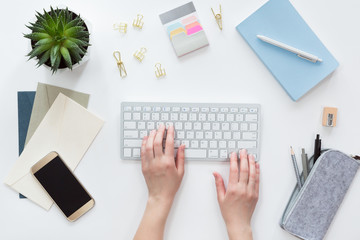 Wall Mural - View from above of woman business workplace with computer keyboard, notebook flat lay.