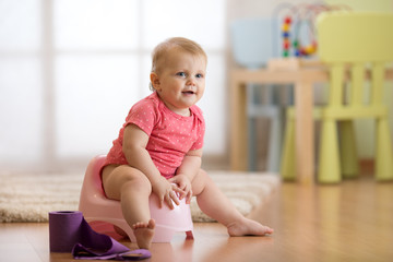 Baby toddler learning how to use chamber pot