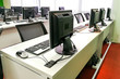 © ThamKC - Empty computer classroom with monitors on top of table