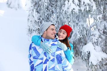 Sticker - Happy couple at beautiful snowy resort. Winter vacation