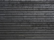 horizontal part of black painted wooden planks of barn wall or shed
