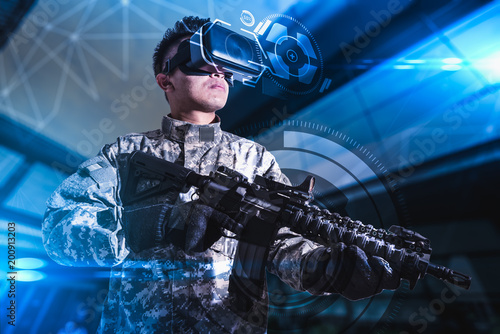 Cuadros en Lienzo The abstract image of the soldier use a VR glasses for combat simulation training overlay with the hologram