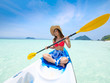 © chayathon2000 - Asian woman on the kayak boat in Andaman blue sea and blue sky background location in Phuket island Thailand