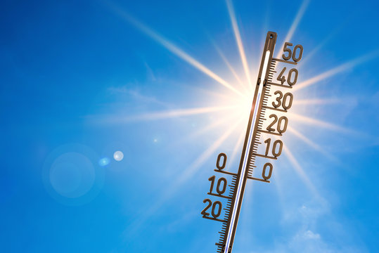 summer background, bright sun with thermometer