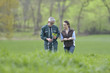 © goodluz - Farmer with agronomist walking in agricultural field