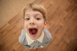 little boy with a mouth open in screaming