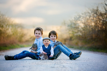 Sticker - Three children, boy brothers in park, playing with little bunnies