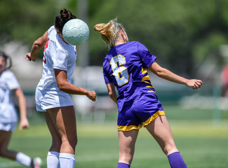 soccer player using head to hit the ball