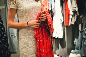 Closeup on hands of a woman holding smartphone on shopping background. Using e-shop technology device, modern consumerism lifestyle