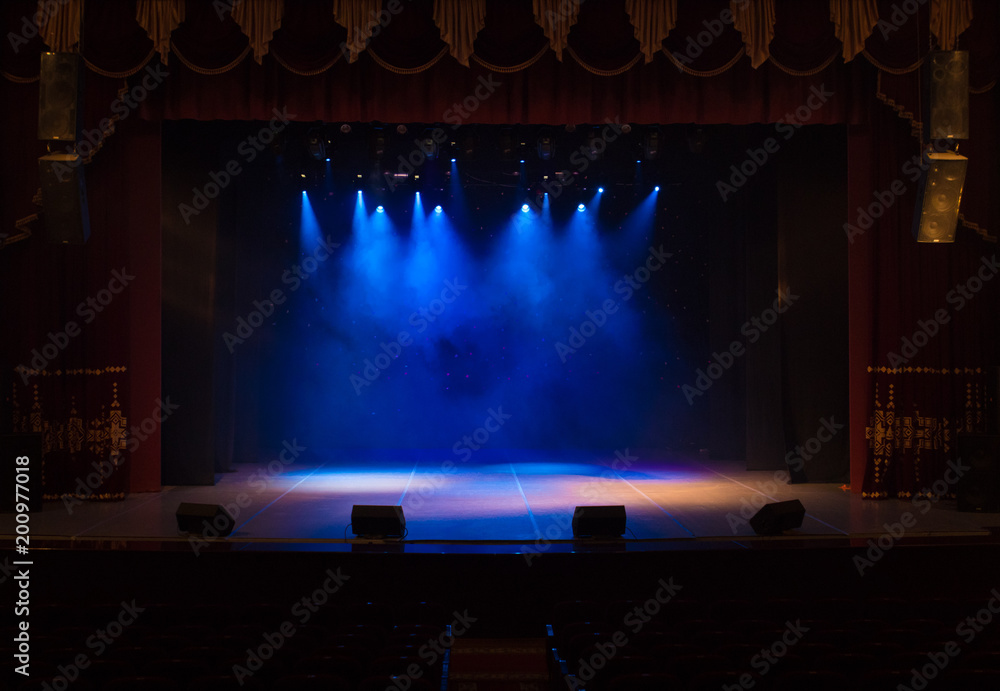 An empty stage of the theater, lit by spotlights and smoke before the performance - obrazy, fototapety, plakaty 