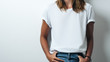 Pretty woman in white blank t-shirt, empty wall, studio close-up