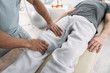 © zinkevych - Professional treatment. Top view of male hands doing a medical massage for the patient