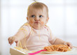 © Oksana Kuzmina - Adorable little baby one year old eating pasta indoor. Funny toddler child with spaghetti. Cute kid and healthy food.