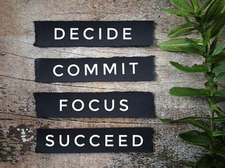 Motivational and inspirational quote - Believe, commit, focus, succeed. With vintage styled background.