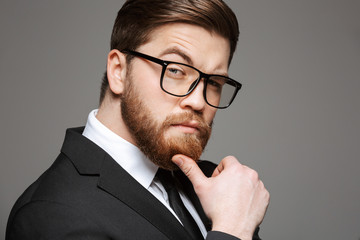 Wall Mural - Close up portrait of a pensive young businessman