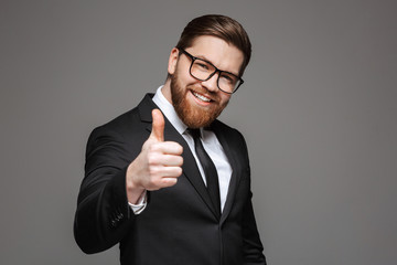 Wall Mural - Portrait of a smiling young businessman dressed in suit