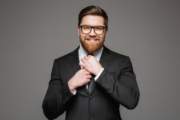 Wall Mural - Portrait of a smiling young businessman dressed in suit