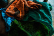 © Yurii Zymovin - Pile of colorful dirty rags laying nearby chopper on the wooden chair. Old garage