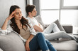 © Drobot Dean - Photo of resentful guy and girl sitting together on couch at home with upset look without conversation, isolated over white background
