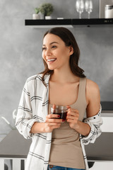 Sticker - Portrait closeup of joyful woman with brown hair looking aside with happy smile, and drinking tea from glass in flat