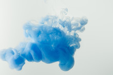 Close Up Shot Of Bright Blue Paint Splash In Water Isolated On Gray